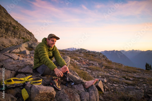 Climber takes his shoes off after a long day in the mountains.