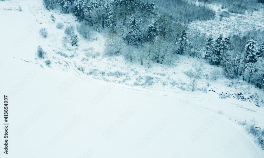 Top view from drone on blue snowy field in winter Top view from drone on blue snowy field in winter