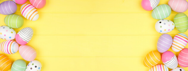Colorful Easter Egg double border over a soft yellow wood banner background. Top view with copy space.