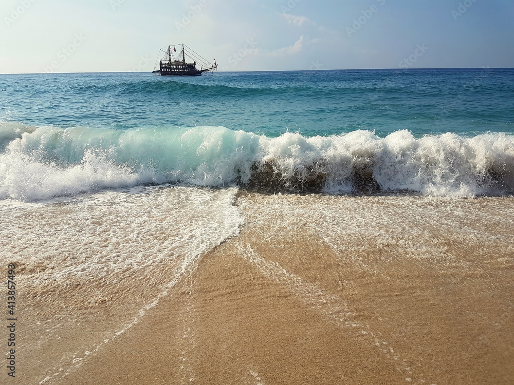Sealine wave on sunny day with pirate yacht, Alanya, Turkey. Vacation concept. Sealine wave on sunny day with pirate yacht, Alanya, Turkey. Vacation concept.