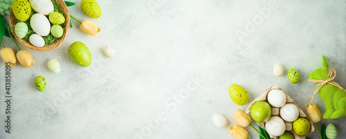 Photography Easter holiday concept with Easter eggs and tulip flowers decor on gray backgrou