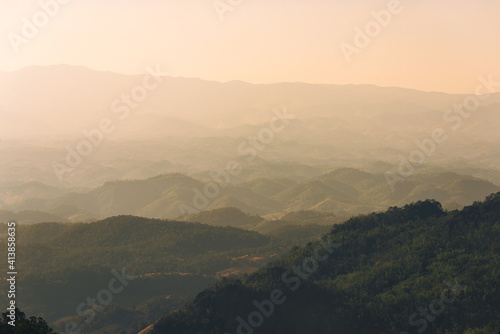 landscape in thailand sunrise on mountains peaceful with mist and sunlight at morning picturesque scenery outdoors travel. © thithawat