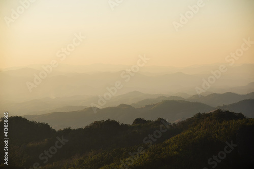 landscape in thailand sunrise on mountains peaceful with mist and sunlight at morning picturesque scenery outdoors travel.