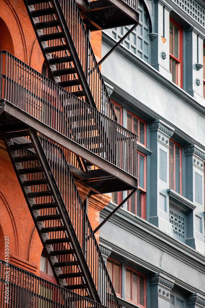 Fire escape with orange and blue surrounding buildings