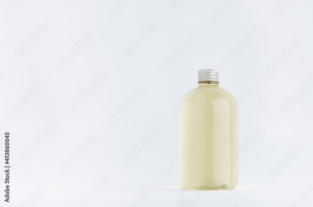 Transparent plastic low thick bottle with pale fresh drink or cosmetic essential oil with silver cap mockup on white background, template, copy space. Transparent plastic low thick bottle with pale fresh drink or cosmetic essential oil with silver cap mockup on white background, template, copy space.