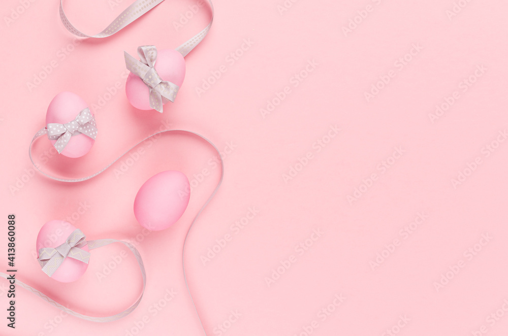 Elegant and girlish easter background - easter eggs with silver bow, wavy ribbons as border on pastel pink backdrop. Elegant and girlish easter background - easter eggs with silver bow, wavy ribbons as border on pastel pink backdrop.