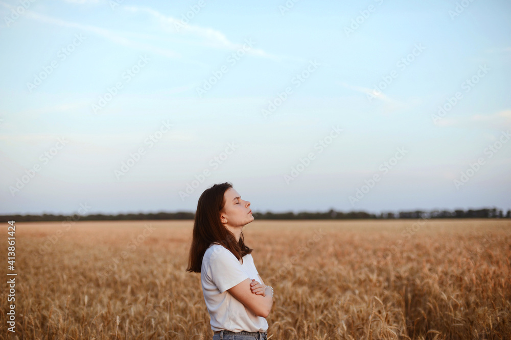 Portrait of young woman standing on wheat field against sky Portrait of young woman standing on wheat field against sky