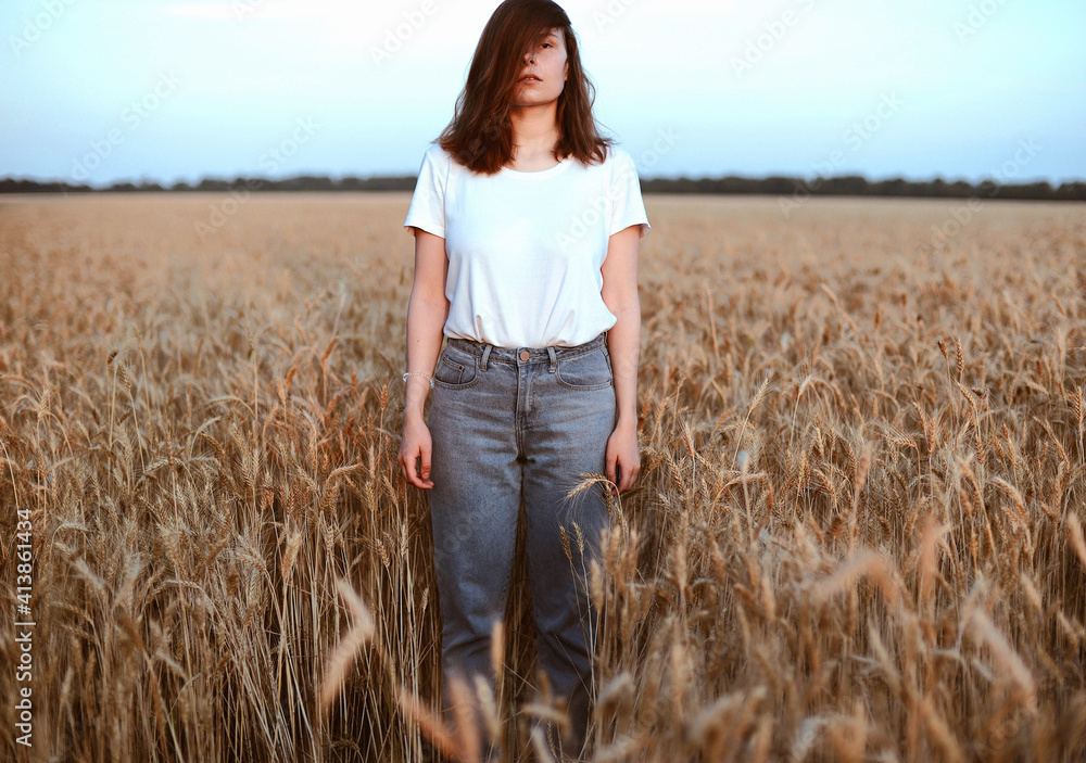 Portrait of young woman standing on wheat field against sky Portrait of young woman standing on wheat field against sky