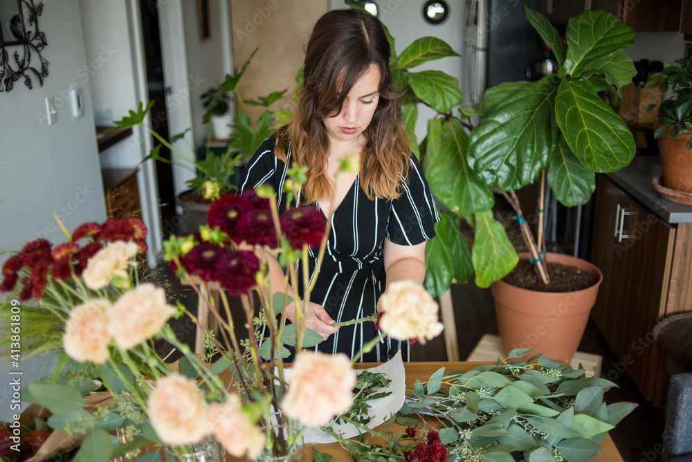 Woman assembling bouquet of flowers Woman assembling bouquet of flowers