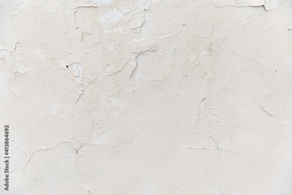 texture of a white old wall with cracks and peeled paint