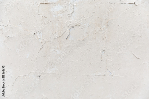 texture of a white old wall with cracks and peeled paint