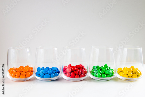 M&M's candy in the glasses, colorful candy, multicolored gradient