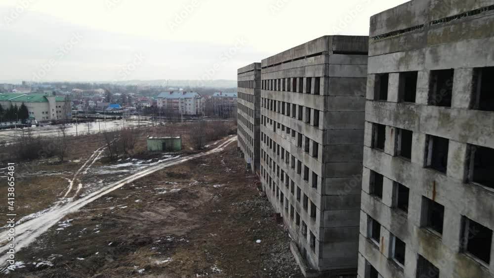 an abandoned high-rise building with broken glass. aerial shooting an abandoned high-rise building with broken glass. aerial shooting