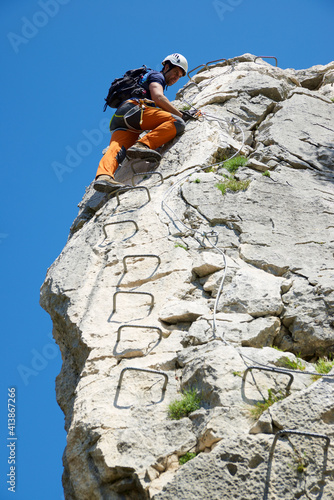 Climbing a ferrata route in Mascun Ravine in Guara Mountains. photo