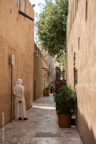 A man rests in a quiet street in the old town of Dubai photo