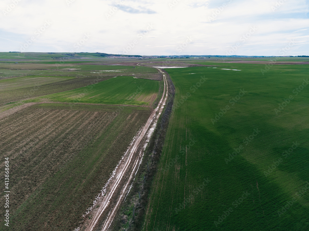 Drone view photo of a flooded dirt road
