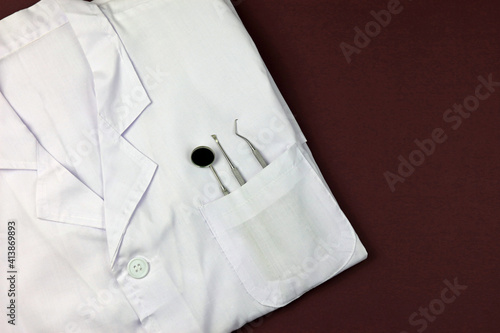 Dental Equipment In The Pocket Of A White Clinical Coat.