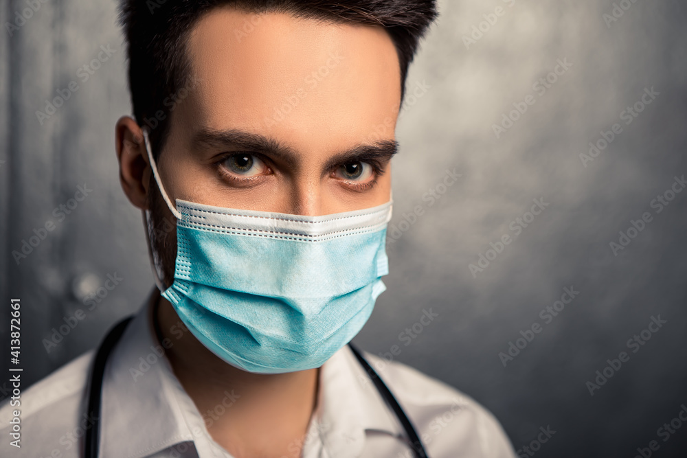 Doctor nurse patient personal protective equipment. Healthcare concept. Man wear white shirt, blue face disposable mask sterilized gloves. Coronavirus pandemic. Stethoscope on the neck
