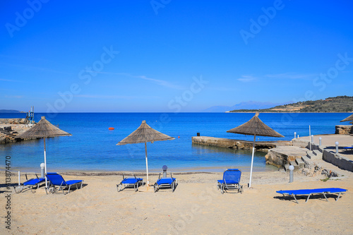 Beach with sun loungers and sun umbrellas in Ksamil resort