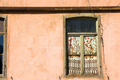 Old windows, house facade and sunlight photo