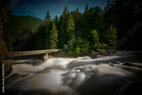 Long exposure shot of Wood Bridge and whitewater in moonlight photo