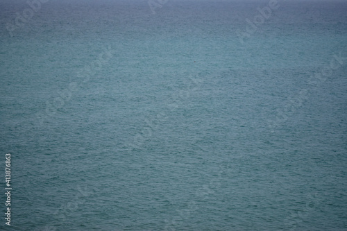 Closeup shot of a calm waveless seawater surface photo