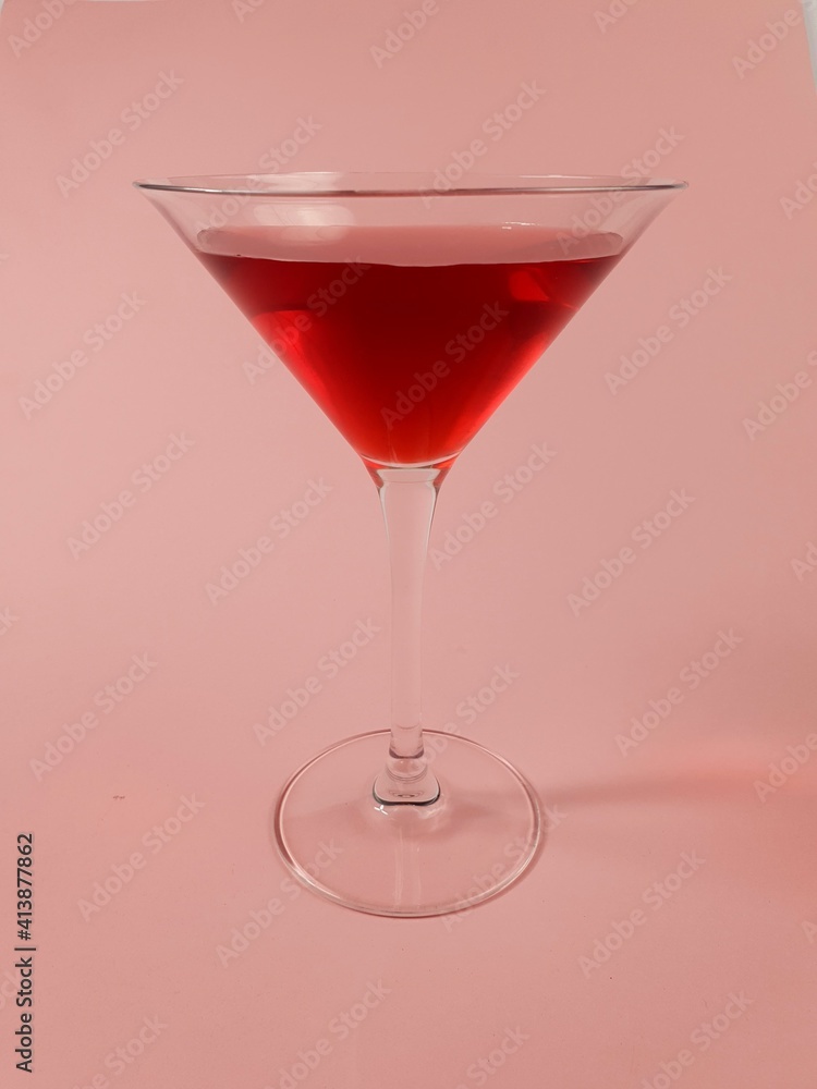 wine glass with red martini on pink background wine glass with red martini on pink background