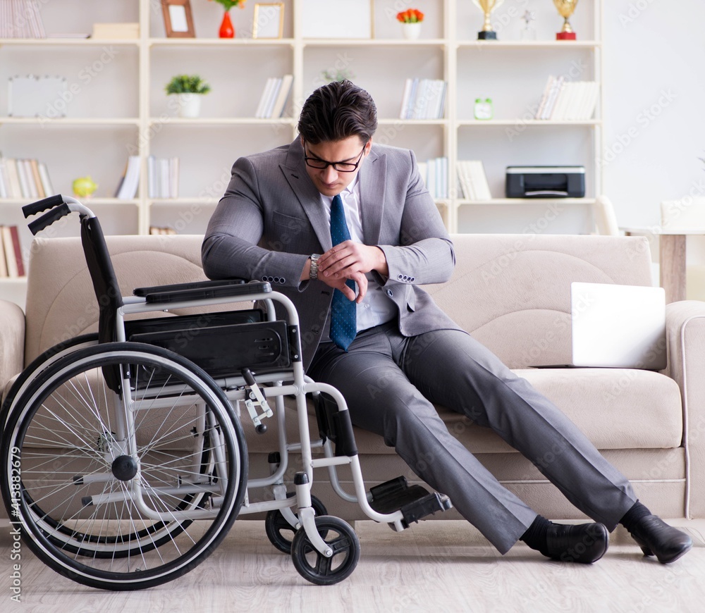 Dsabled businessman on wheelchair working home Dsabled businessman on wheelchair working home