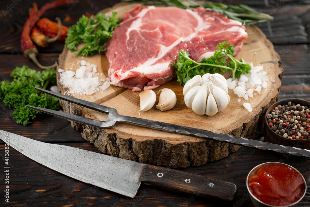 Raw meat with spices in a composition with kitchen accessories. Raw meat with spices in a composition with kitchen accessories.