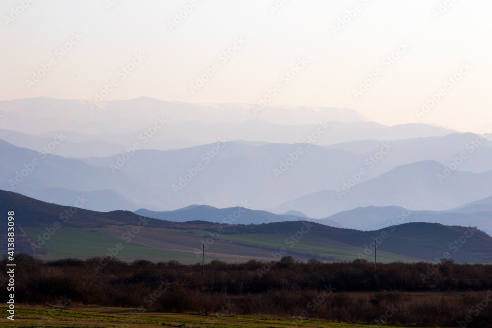 Mountain range landscape during sunset, view of mountain and peak lines, horizon