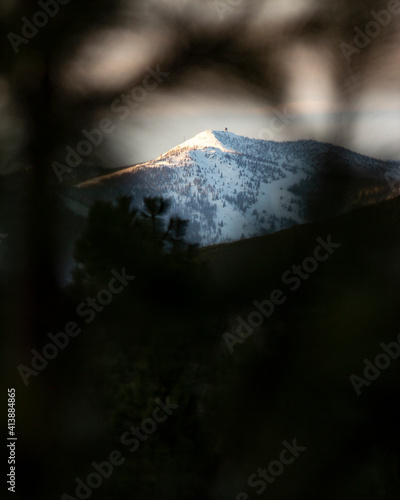 A snowy mountain called Point Six with a weather station on top. photo