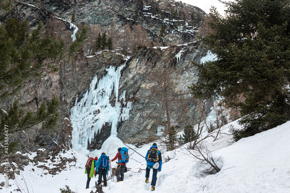 Group hiking to icy waterfall, Cogne, Aosta Valley, Italy