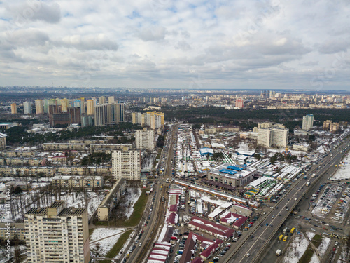 Kyiv road junction in light snow. Aerial drone view. Winter cloudy morning. © Sergey