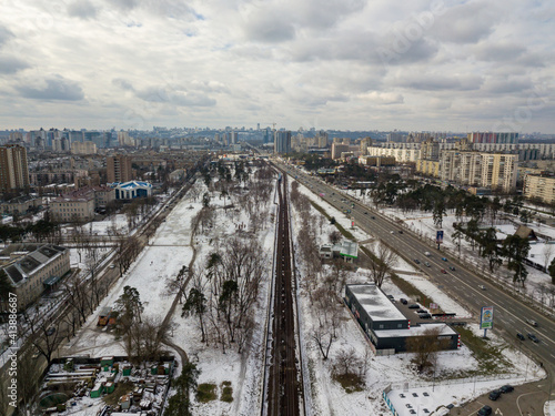 Kiev metro line in a snowy park. Aerial drone view. Winter snowy morning.