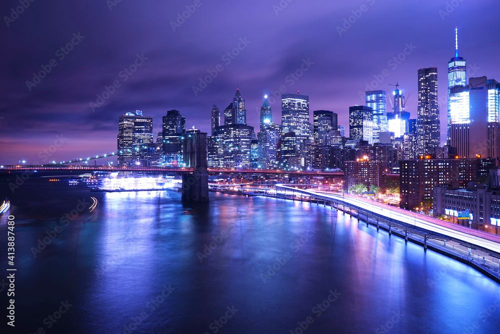 Brooklyn Bridge over river against illuminated city Brooklyn Bridge over river against illuminated city