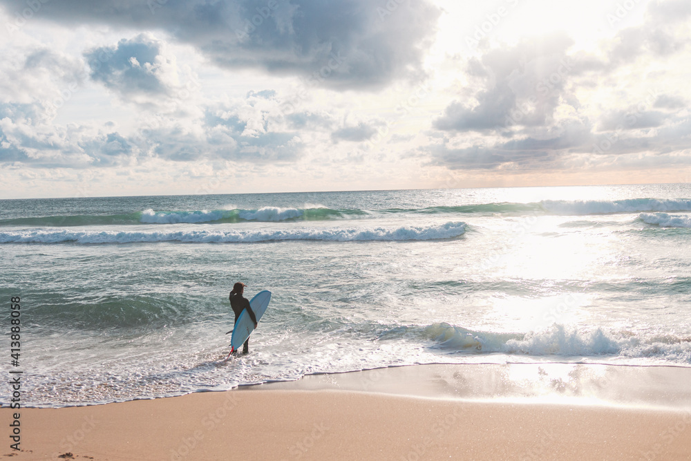 Surfer looking at the waves, culs nuls beach, hossegor, landes, france Surfer looking at the waves, culs nuls beach, hossegor, landes, france