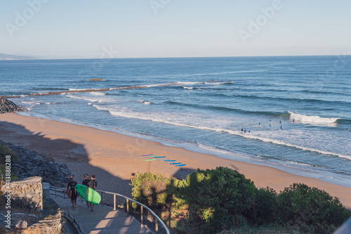 Surfers in Milady Beach, Biarritz, Pays Basque, France photo