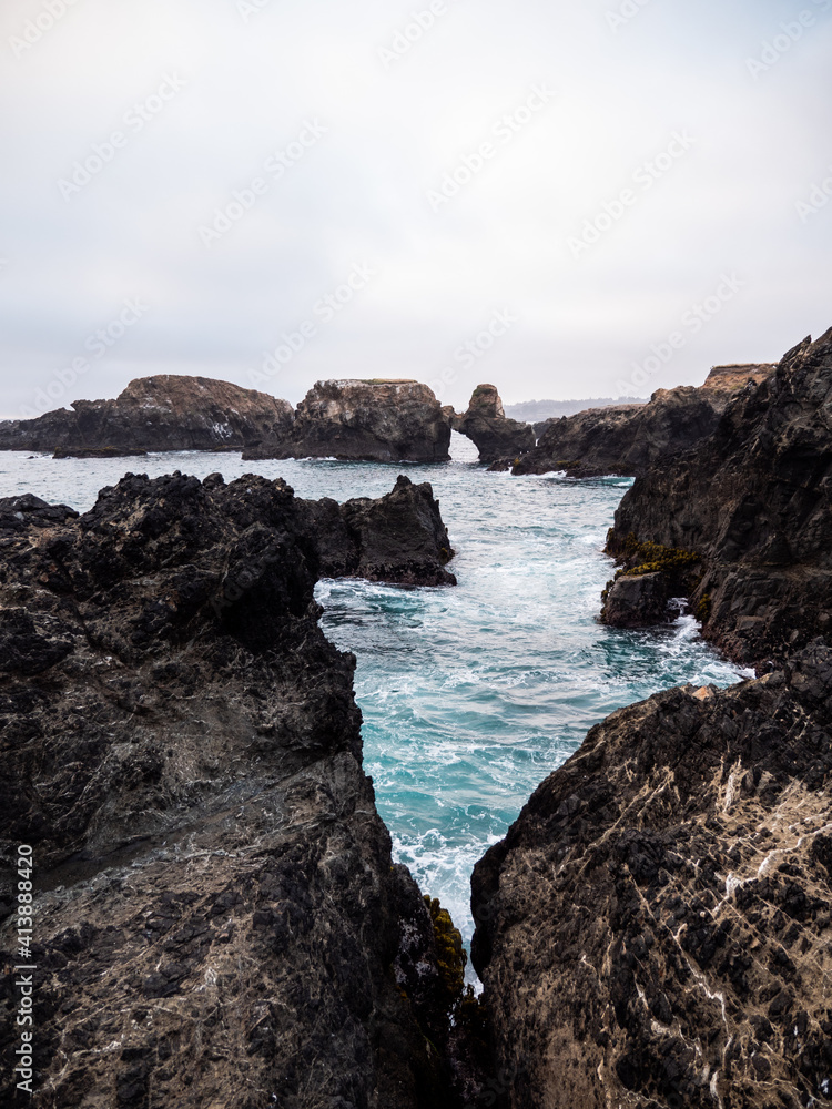 Vertical image of blue ocean and coastal rocks Vertical image of blue ocean and coastal rocks