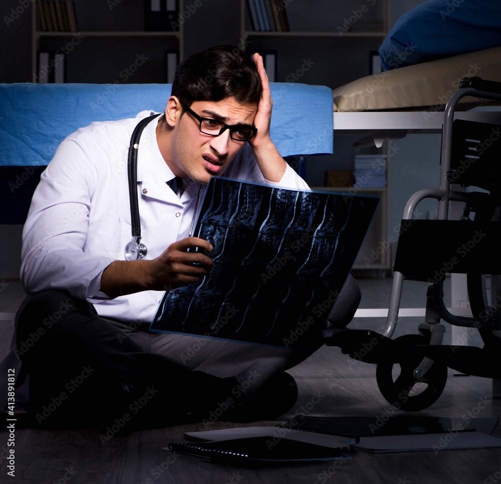 Doctor working night shift in hospital after long hours Doctor working night shift in hospital after long hours