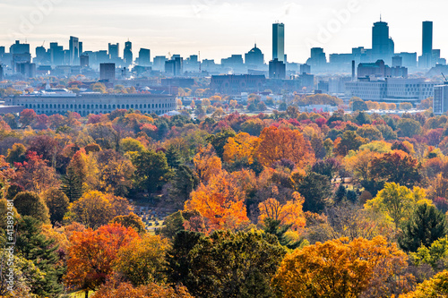 Fall foliage colors popping in front of city skyline. photo