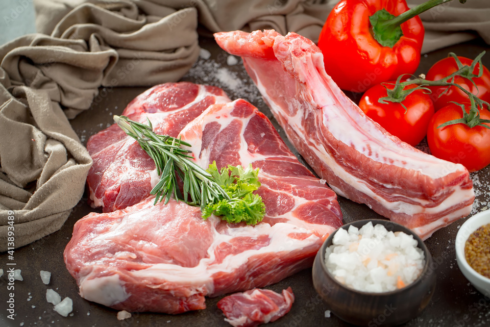 Raw meat with spices in a composition with kitchen accessories. Raw meat with spices in a composition with kitchen accessories.