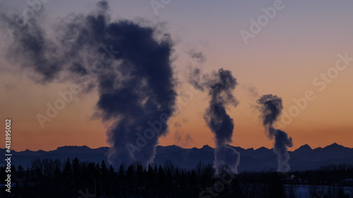 Extraction Plant smoke rises in -30C temps during sunset photo