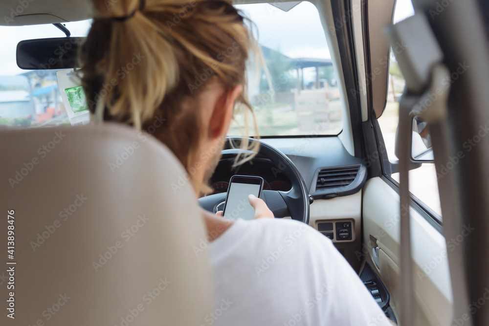 Rear view of man using mobile phone while sitting in car Rear view of man using mobile phone while sitting in car
