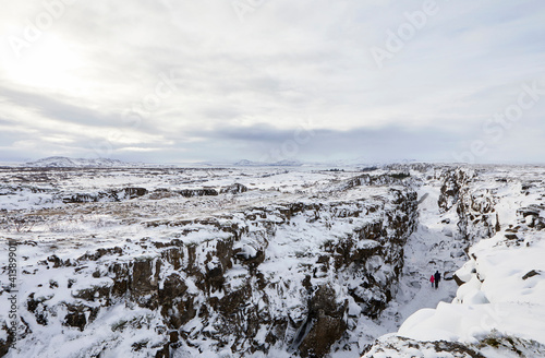Wallpaper Mural Distant view of father and daughter amidst snow covered rock formations against sky Torontodigital.ca