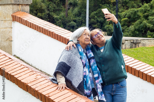 Senior mother and adult daughter traveling. The famous historic Bridge of Boyaca in Colombia. The Colombian independence Battle of Boyaca took place here on August 7, 1819. photo