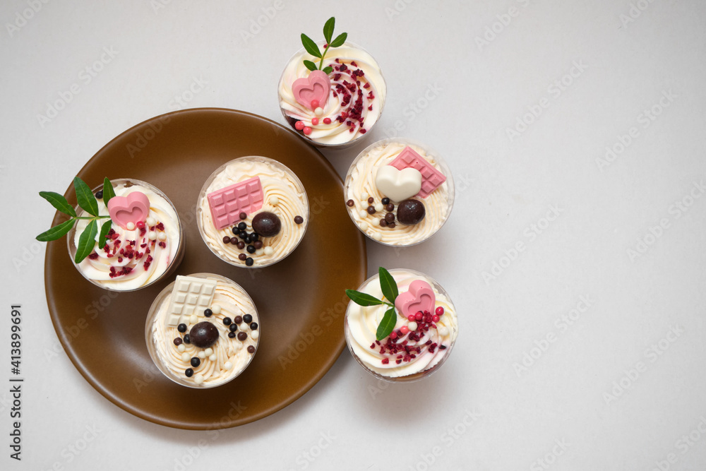 Trifles portioned mini cakes on plate. Layered trifle dessert with whipped cream and chocolate