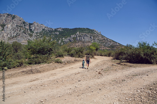 boy child travels with his father through the mountains in the summer in the Crimea