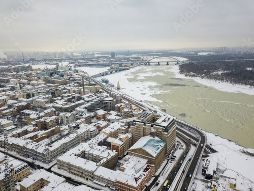 The freezing Dnieper river in Kiev. Snowy textures on the freezing river. Aerial drone view. Winter snowy morning.