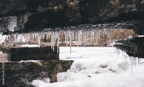 Wallpaper Mural Icicles hanging on wall against frozen river Torontodigital.ca