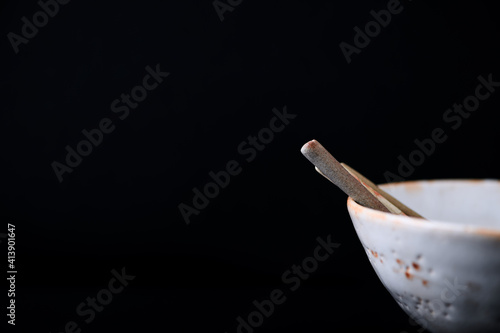 Traditional, handcrafted ceramic on dark background. Soft focus. Copy space.
